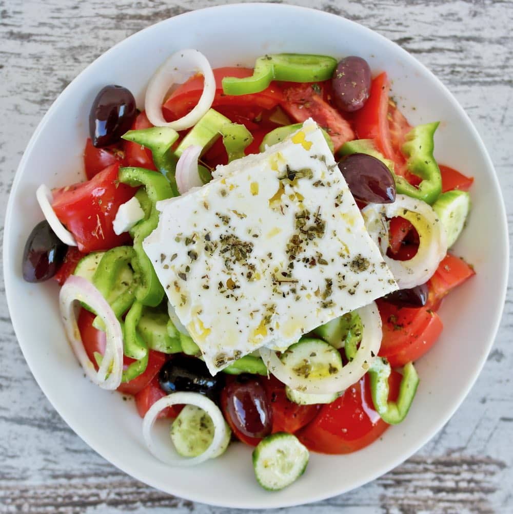 Photo of a Greek salad (tomatoes, cucumber, pepper, onion and olives) with feta cheese