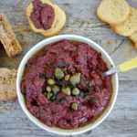 Black olive tapenade in bowl with toasts