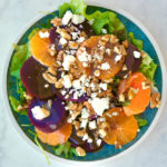 Beet salad with tangerines and feta on a plate