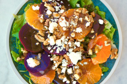 Beet salad with tangerines and feta on a plate