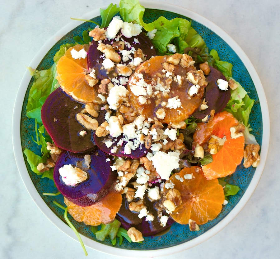 Beet salad with tangerines and feta on a plate